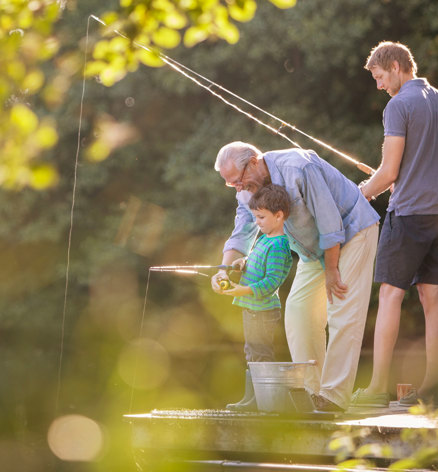 Family fishing at Finlake Holiday Park river